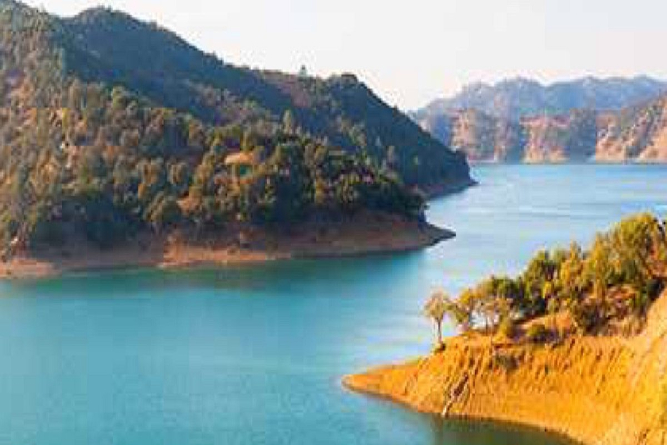 Lake Berryessa CA - Transparent Window Washing Serene turquoise lake edged by forested hills and rocky shores.